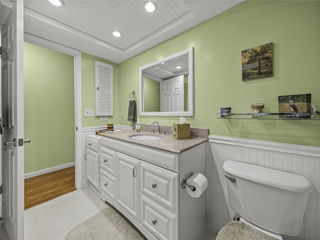 bathroom featuring hardwood / wood-style floors, vanity, and toilet