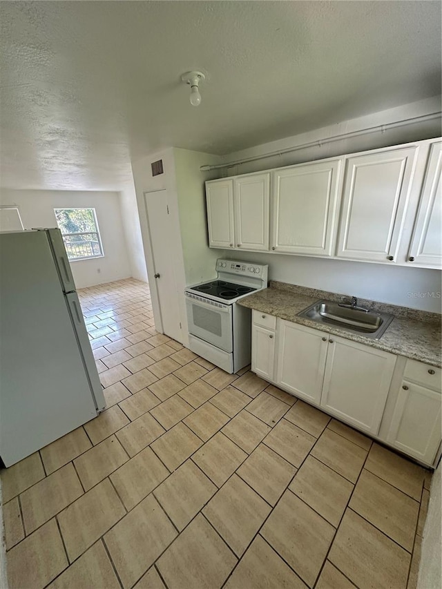 kitchen with white cabinetry, white appliances, sink, and a textured ceiling