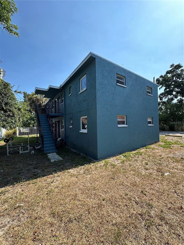 view of property exterior with a yard