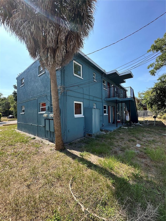 rear view of property with a balcony