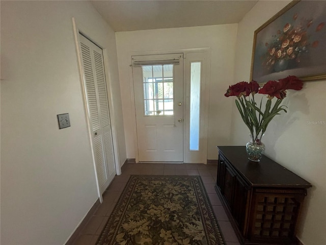 doorway to outside featuring tile patterned flooring