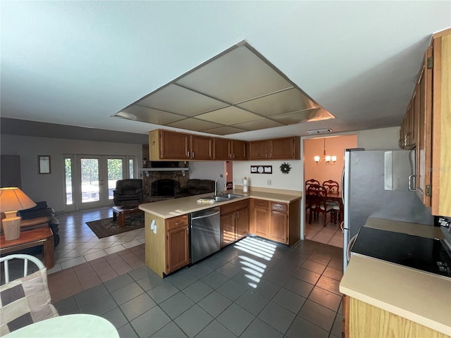 kitchen featuring stainless steel dishwasher, kitchen peninsula, sink, and tile patterned flooring