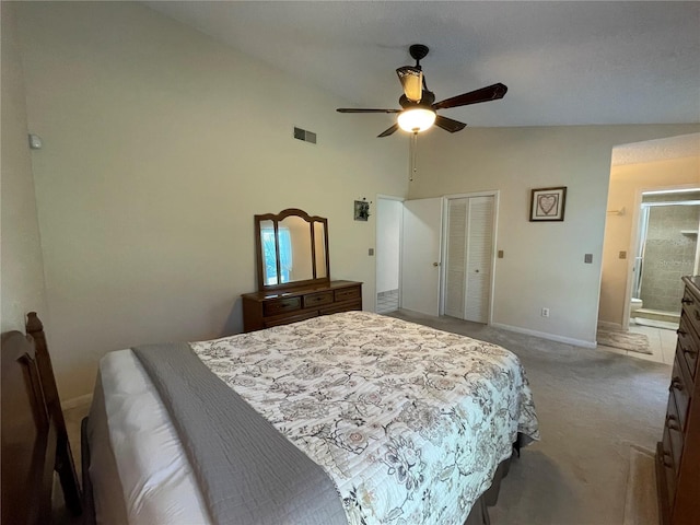 bedroom with ensuite bathroom, ceiling fan, carpet flooring, a closet, and vaulted ceiling