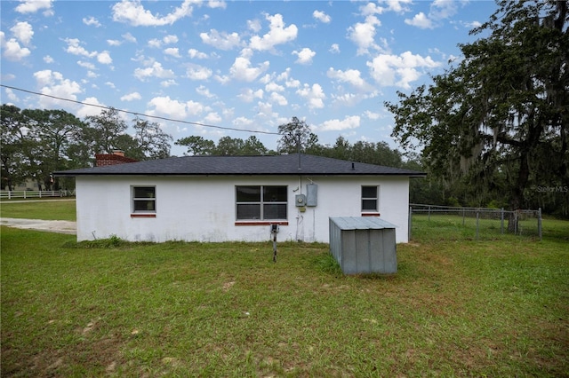 view of side of property with a lawn