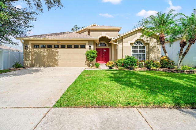 view of front of house with a front yard and a garage