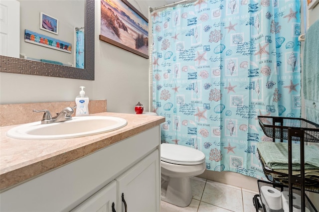 bathroom featuring curtained shower, toilet, vanity, and tile patterned flooring