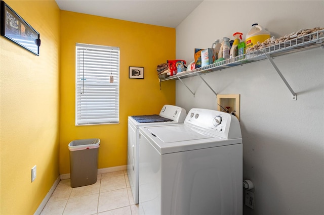 laundry area featuring light tile patterned floors and washer and dryer