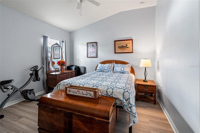 bedroom featuring ceiling fan, light hardwood / wood-style floors, and vaulted ceiling