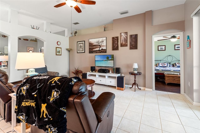 living room featuring ceiling fan and light tile patterned floors