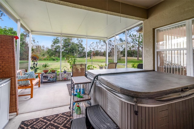 sunroom featuring a hot tub