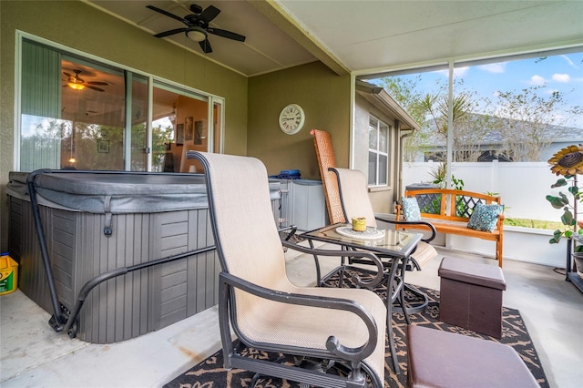 sunroom featuring ceiling fan and a jacuzzi