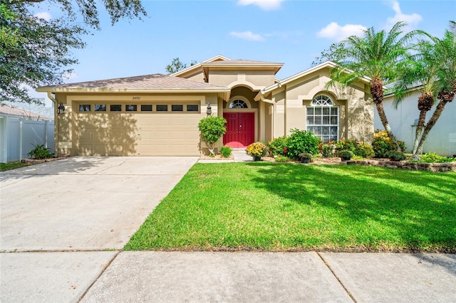 view of front facade with a front yard and a garage