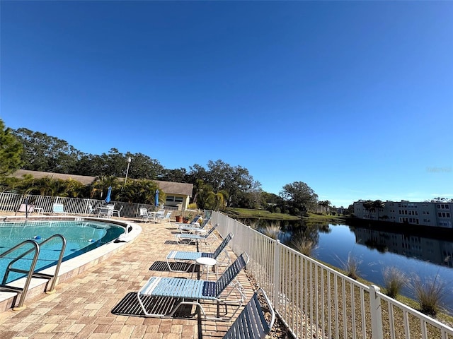 view of pool with a water view and a patio area