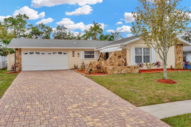 ranch-style home with a front lawn and a garage