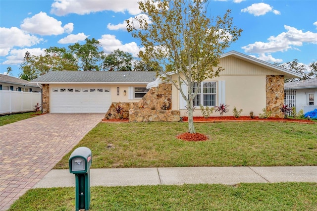 single story home with a front lawn and a garage