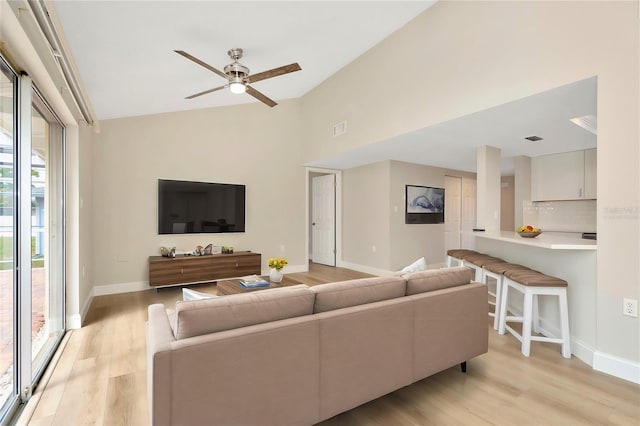 living room with light hardwood / wood-style floors and ceiling fan