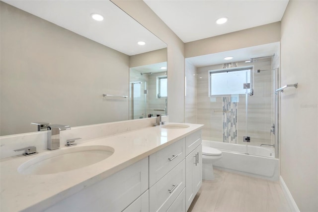 full bathroom with toilet, vanity, and enclosed tub / shower combo