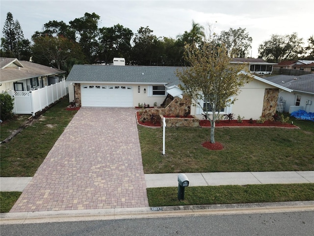 view of front facade with a garage and a front lawn