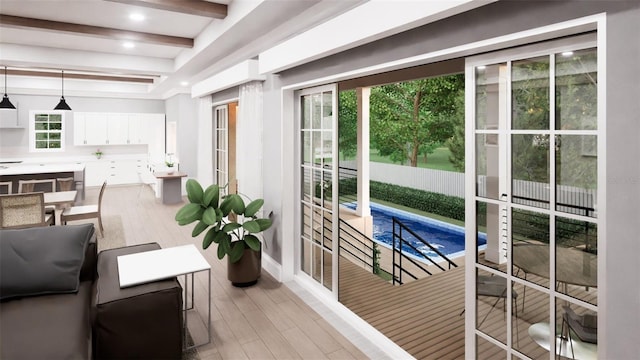 doorway featuring light hardwood / wood-style flooring and beamed ceiling