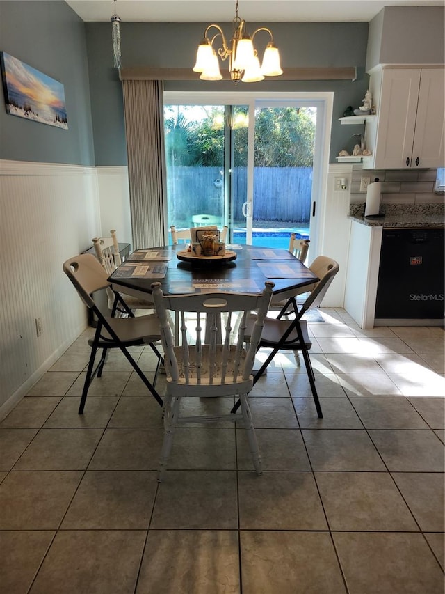 dining area featuring plenty of natural light, a chandelier, and tile patterned flooring