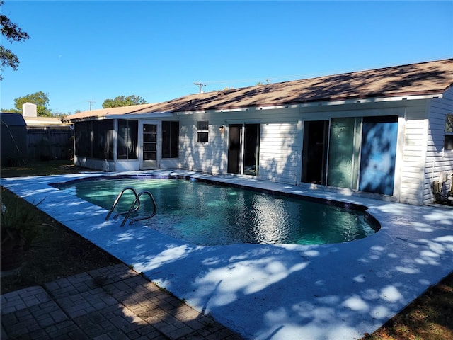 view of swimming pool featuring a sunroom