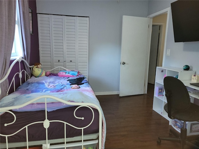 bedroom featuring a closet and dark hardwood / wood-style floors