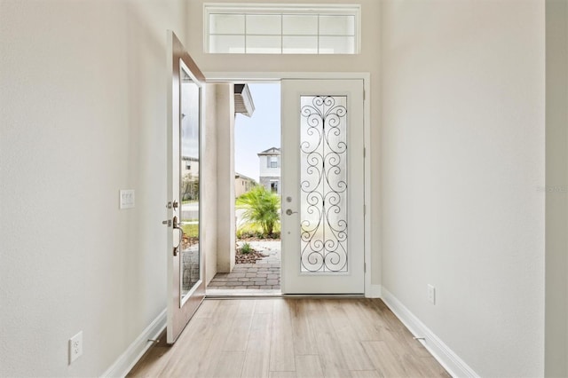 entryway featuring light wood-style floors and baseboards