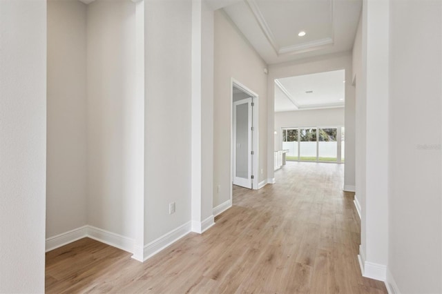 hallway featuring light wood-style floors, baseboards, and recessed lighting