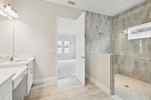 full bath featuring a shower stall, visible vents, baseboards, and vanity