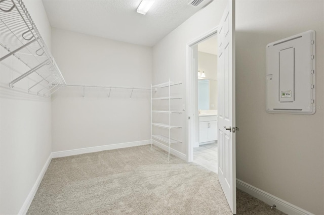 walk in closet featuring light carpet and visible vents