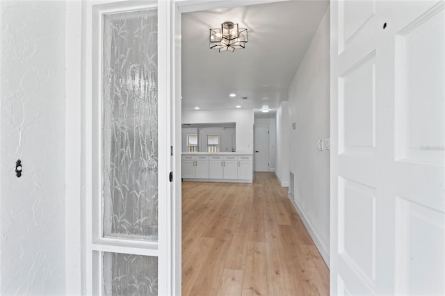 hallway with light hardwood / wood-style flooring