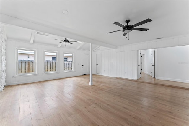 unfurnished living room featuring light hardwood / wood-style floors, beamed ceiling, and ceiling fan