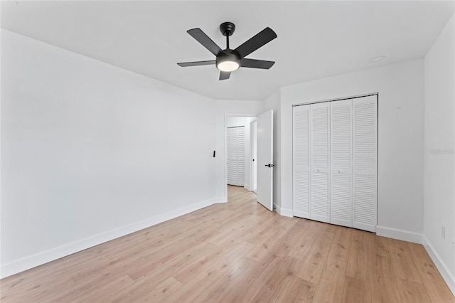 unfurnished bedroom with a closet, light wood-type flooring, and ceiling fan