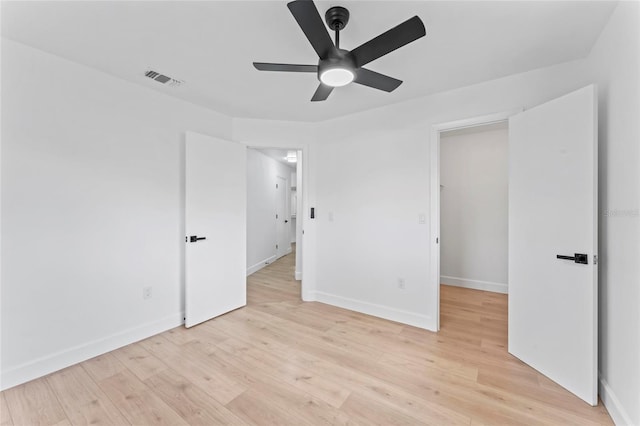 spare room featuring ceiling fan and light wood-type flooring