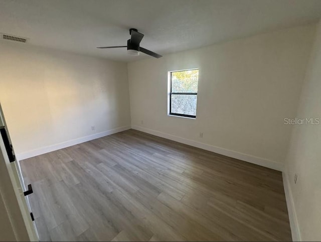 empty room featuring hardwood / wood-style floors and ceiling fan