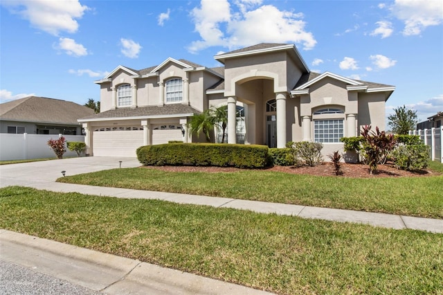 view of front of property featuring a garage, a front lawn, and a balcony