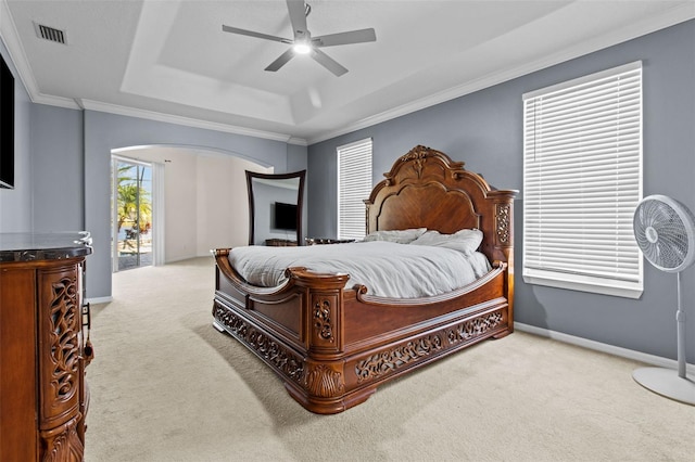 bedroom with light carpet, ceiling fan, access to exterior, a tray ceiling, and crown molding