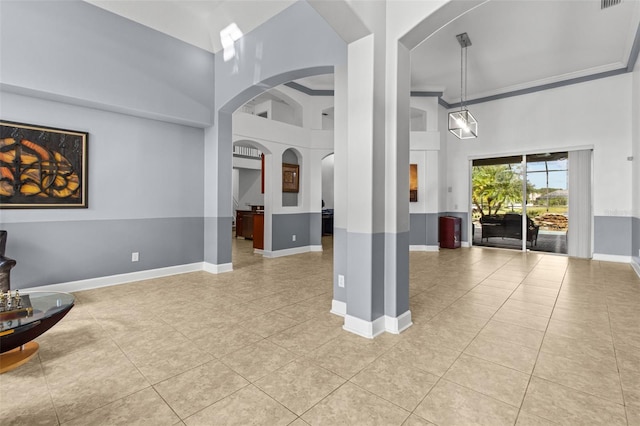 interior space with a high ceiling and light tile patterned floors