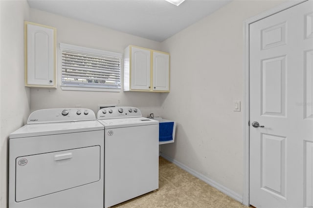 clothes washing area featuring washing machine and dryer, cabinets, sink, and light tile patterned flooring