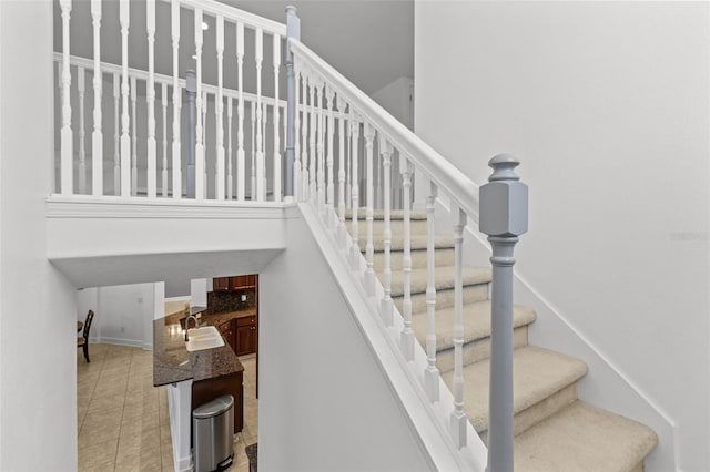 stairway with sink and tile patterned flooring