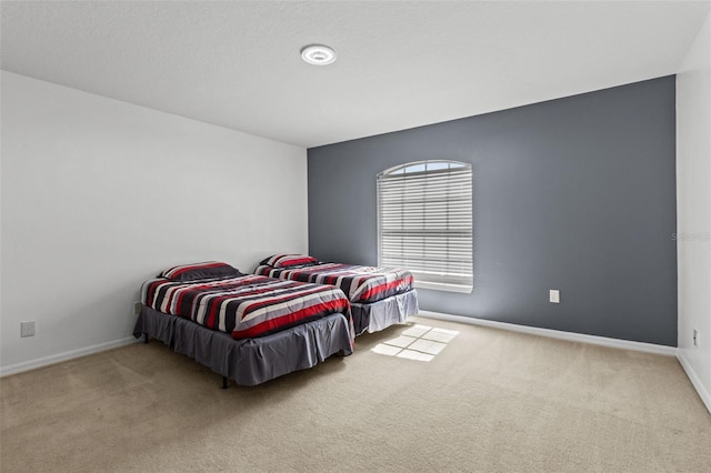 bedroom featuring light carpet