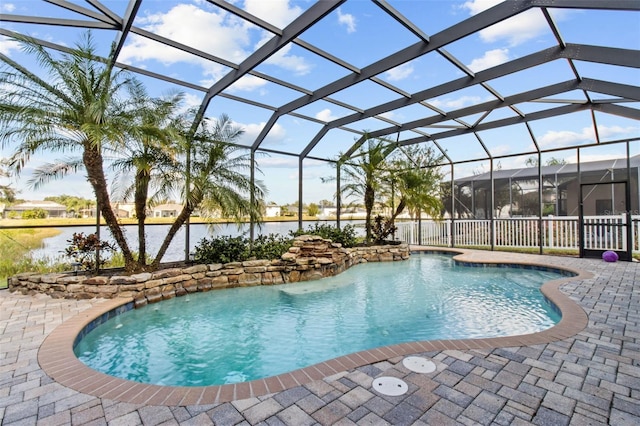 view of swimming pool featuring a water view, glass enclosure, and a patio area