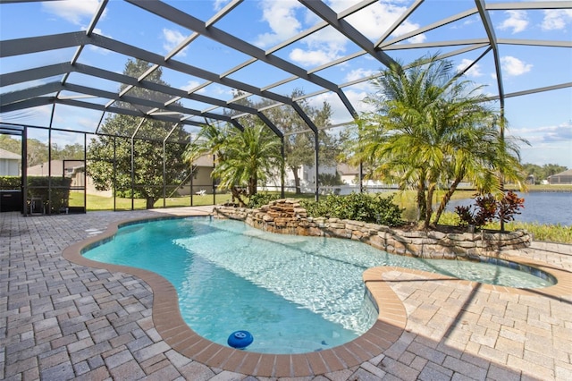 view of swimming pool with glass enclosure, a patio area, and a water view