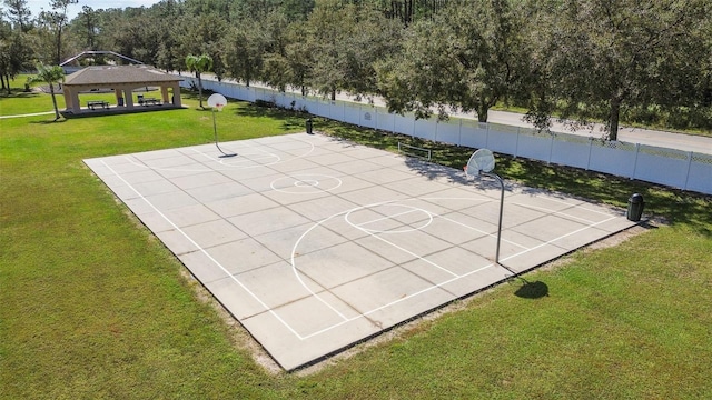 view of sport court featuring a lawn and a gazebo