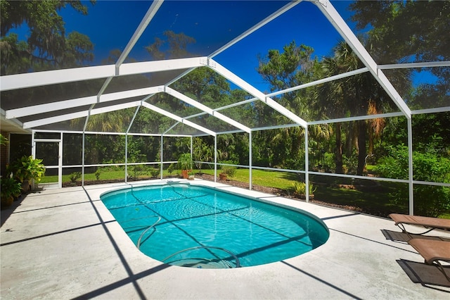 view of swimming pool with a patio and glass enclosure