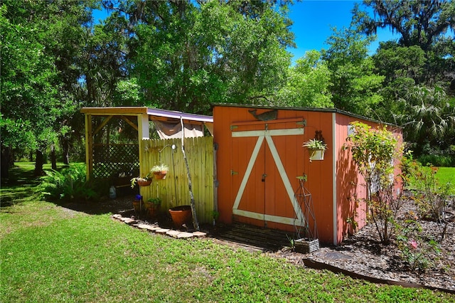 view of outdoor structure featuring a lawn