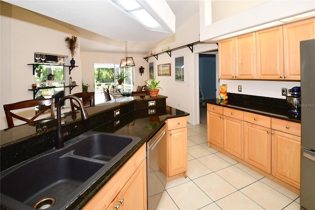 kitchen featuring stainless steel appliances, sink, light tile patterned flooring, light brown cabinets, and dark stone countertops