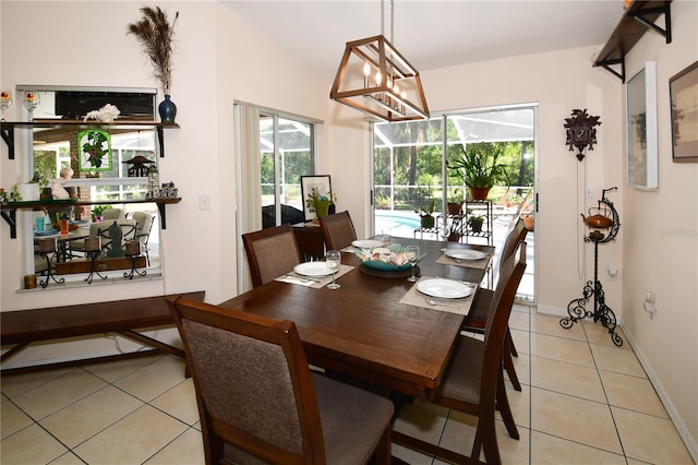 tiled dining area featuring vaulted ceiling