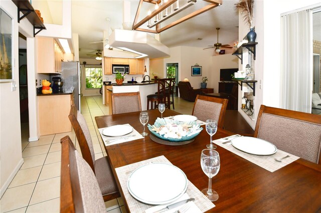 tiled dining space with ceiling fan