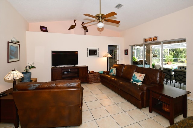 living room featuring lofted ceiling, ceiling fan, and light tile patterned floors